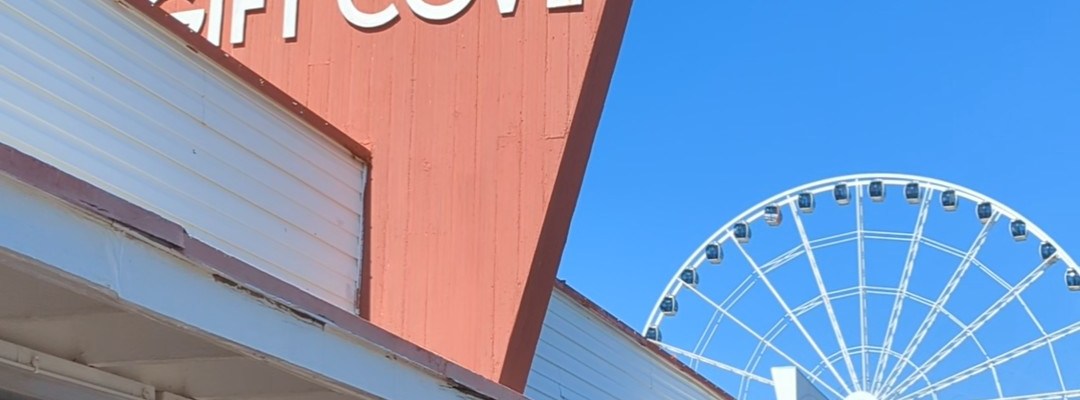 View of exterior Gay Dolphin Gift Cove big wooden red sign