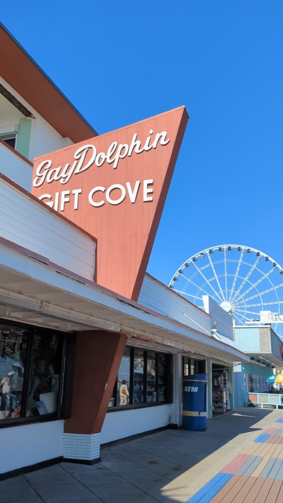 View of exterior Gay Dolphin Gift Cove big wooden red sign